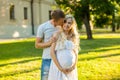 Happy young pregnant couple hugging in nature Royalty Free Stock Photo