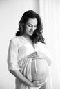 Young pregnant woman in lace nightgown