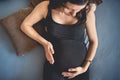 young pregnant woman laying on bed and relaxing, talking to the baby Royalty Free Stock Photo