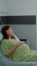 Young pregnant woman laying in hospital ward bed Royalty Free Stock Photo