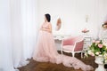 Young pregnant woman in a light classic interior. Royalty Free Stock Photo