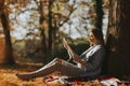 Young pregnant woman looking fetus ultrasound images in the park Royalty Free Stock Photo