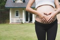 young pregnant woman making heart shape sign on her tummy in fro Royalty Free Stock Photo