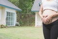 young pregnant woman making heart shape sign on her tummy in fro Royalty Free Stock Photo