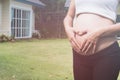 young pregnant woman making heart shape sign on her tummy in fro Royalty Free Stock Photo