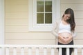 young pregnant woman making heart shape sign on her tummy in fro Royalty Free Stock Photo