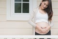 young pregnant woman making heart shape sign on her tummy in fro Royalty Free Stock Photo