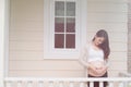 young pregnant woman making heart shape sign on her tummy in fro Royalty Free Stock Photo