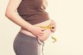 Young pregnant woman measures her belly Royalty Free Stock Photo