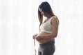 Young pregnant woman measuring belly centimeter, healthcare and pregnancy care Royalty Free Stock Photo