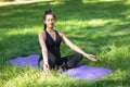 A young pregnant woman meditates sitting in a lotus position with jnana mudra