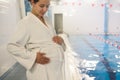 Young pregnant woman near a swimming pool. Royalty Free Stock Photo