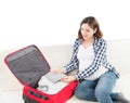 Young pregnant woman packing on a sofa