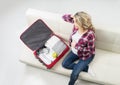 Young pregnant woman packing on a sofa Royalty Free Stock Photo