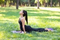 Young pregnant woman practicing yoga, doing Urdhva Mukha Svanasana, upward facing dog pose Royalty Free Stock Photo