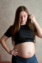 Young pregnant woman. Pregnant beautiful woman posing at home