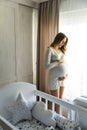 Young pregnant woman prepares for the arrival of baby Royalty Free Stock Photo