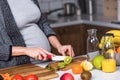 Young pregnant woman preparing healthy food with fruit and vegetables Royalty Free Stock Photo