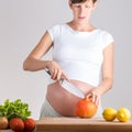 Young pregnant woman preparing vegetables Royalty Free Stock Photo