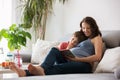 Young pregnant woman, reading a book at home to her boy Royalty Free Stock Photo