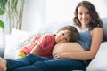 Young pregnant woman, reading a book at home to her boy Royalty Free Stock Photo