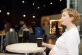 Young pregnant woman resting and drinking coffee at the table of cafe in shopping mall. Nutrition during pregnancy. Royalty Free Stock Photo