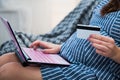 Young Pregnant Woman Shopping Online With Laptop Credit Card Close-up