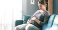 Happy pregnant woman relaxing on the sofa at home Royalty Free Stock Photo