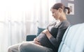 Happy pregnant woman relaxing on the sofa at home Royalty Free Stock Photo