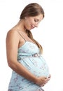 Young pregnant woman smiling while looking at her belly Royalty Free Stock Photo