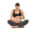 Young pregnant woman in sportswear on white background Royalty Free Stock Photo