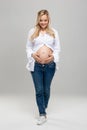 Young pregnant woman in studio. Beautiful stomach. Pregnancy, childbearding and new life concept. Royalty Free Stock Photo