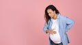 Young pregnant woman suffering from labor pains on pink Royalty Free Stock Photo