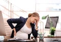 Young pregnant woman suffering from pain while working Royalty Free Stock Photo