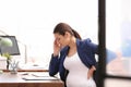 Young pregnant woman suffering from pain while working Royalty Free Stock Photo