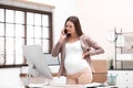 Young pregnant woman suffering from pain while working Royalty Free Stock Photo