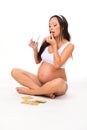 Young pregnant woman taking a pill, prenatal vitamins Royalty Free Stock Photo