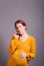 Young pregnant woman talking on mobile phone Royalty Free Stock Photo