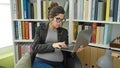 Young pregnant woman teacher using laptop at library university Royalty Free Stock Photo