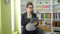 Young pregnant woman teacher using touchpad at library university Royalty Free Stock Photo