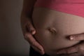 Young pregnant woman touches her belly. Dramatic light Royalty Free Stock Photo