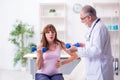 Young pregnant woman visiting old male doctor gynecologist Royalty Free Stock Photo