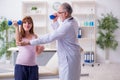 Young pregnant woman visiting old male doctor gynecologist Royalty Free Stock Photo