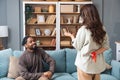 Young pregnant woman wants to surprise her husband with a positive pregnancy test and has tied a decorative bow to be her gift to Royalty Free Stock Photo