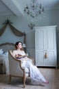 Young pregnant woman in white dress sitting Royalty Free Stock Photo