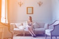 Young pregnant woman in white dress sitting Royalty Free Stock Photo