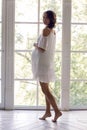 Young pregnant woman in white dress in the studio Royalty Free Stock Photo