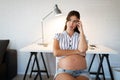 Pregnant woman working from home. Career and pregnancy concept