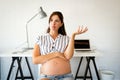 Pregnant woman working from home. Career and pregnancy concept