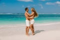 Young pregnant woman with husband relaxing at paradise beach. Happy couple in tropics Royalty Free Stock Photo